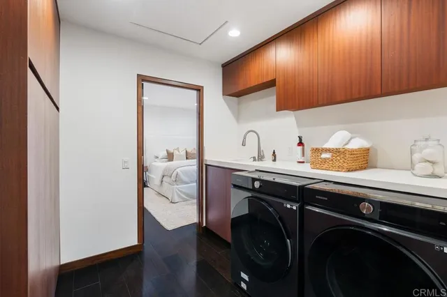 a room with a potted plant and kitchen view