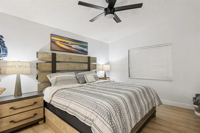 a bedroom with a bed and a dresser with the shoe rack