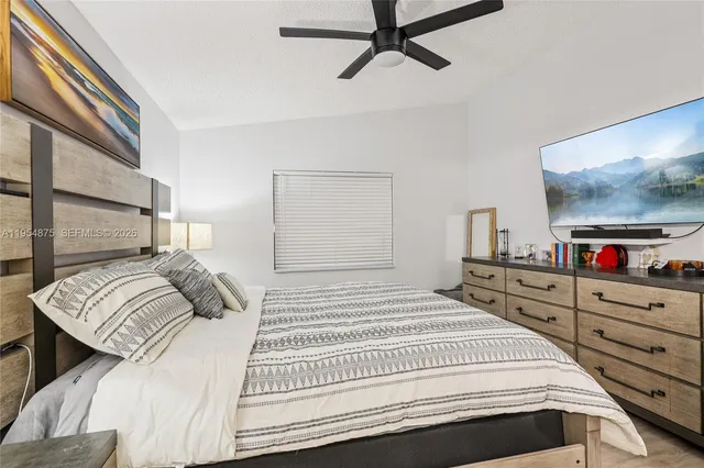 a bedroom with a bed and a flat tv screen