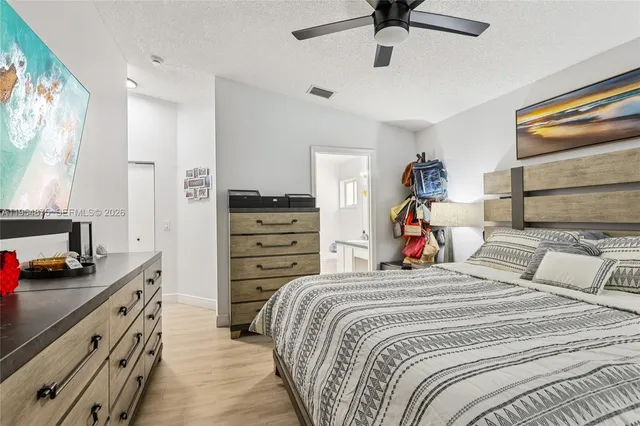 a bed room with a bed and a flat screen tv