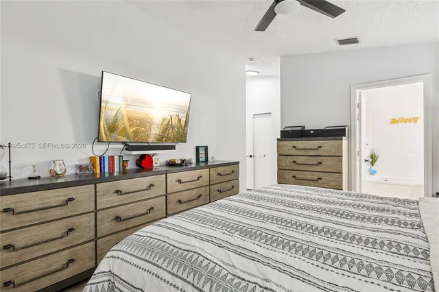 a bathroom with a granite countertop sink and a tub