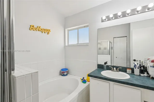 a white bath tub sitting next to a white door