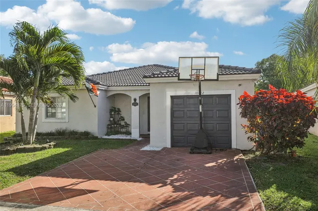 a front view of a house with a yard and garage