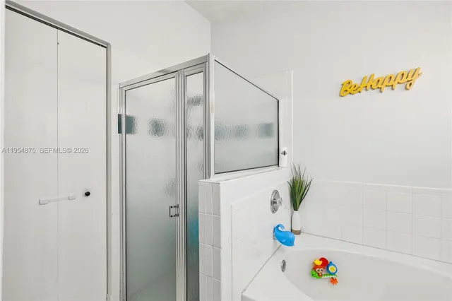 a bathroom with a granite countertop toilet and a shower