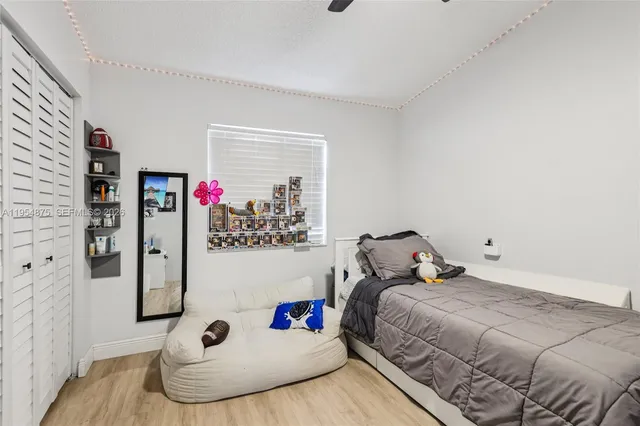 a bedroom with a bed and wooden floor