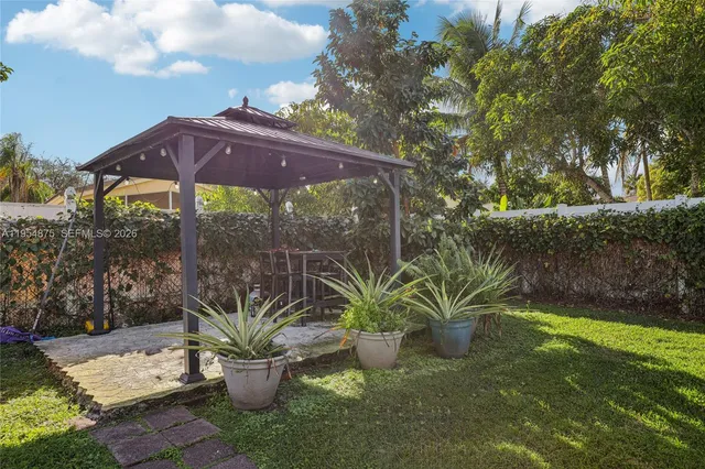 an aerial view of a house with a yard and garden
