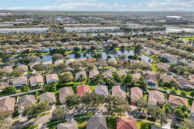 an aerial view of a house with garden space and street view