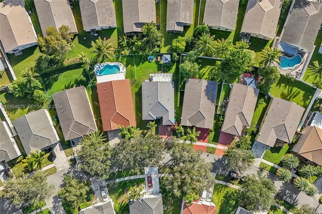 an aerial view of residential houses with outdoor space