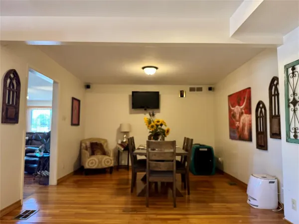 a living room with furniture flat screen tv and a large window