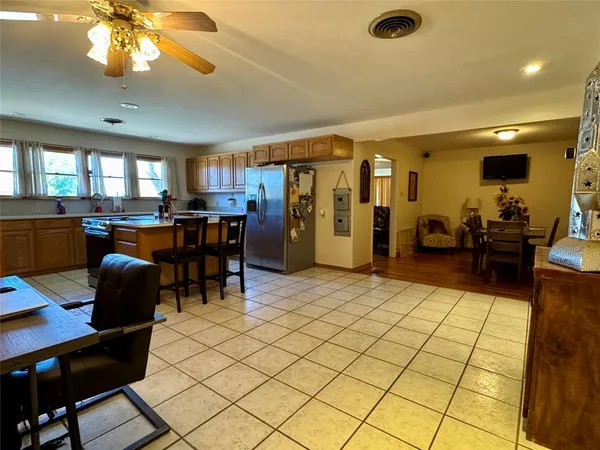 a spacious bedroom with a bed and a chandelier