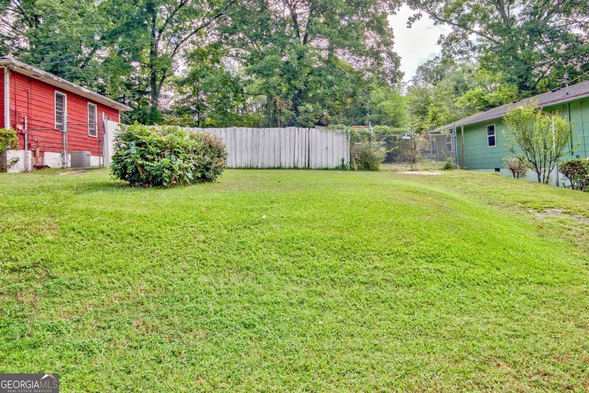 175 Fairfield Place Northwest Atlanta, GA 30314 - Photo 2 of 2 a backyard of a house with plants and large tree