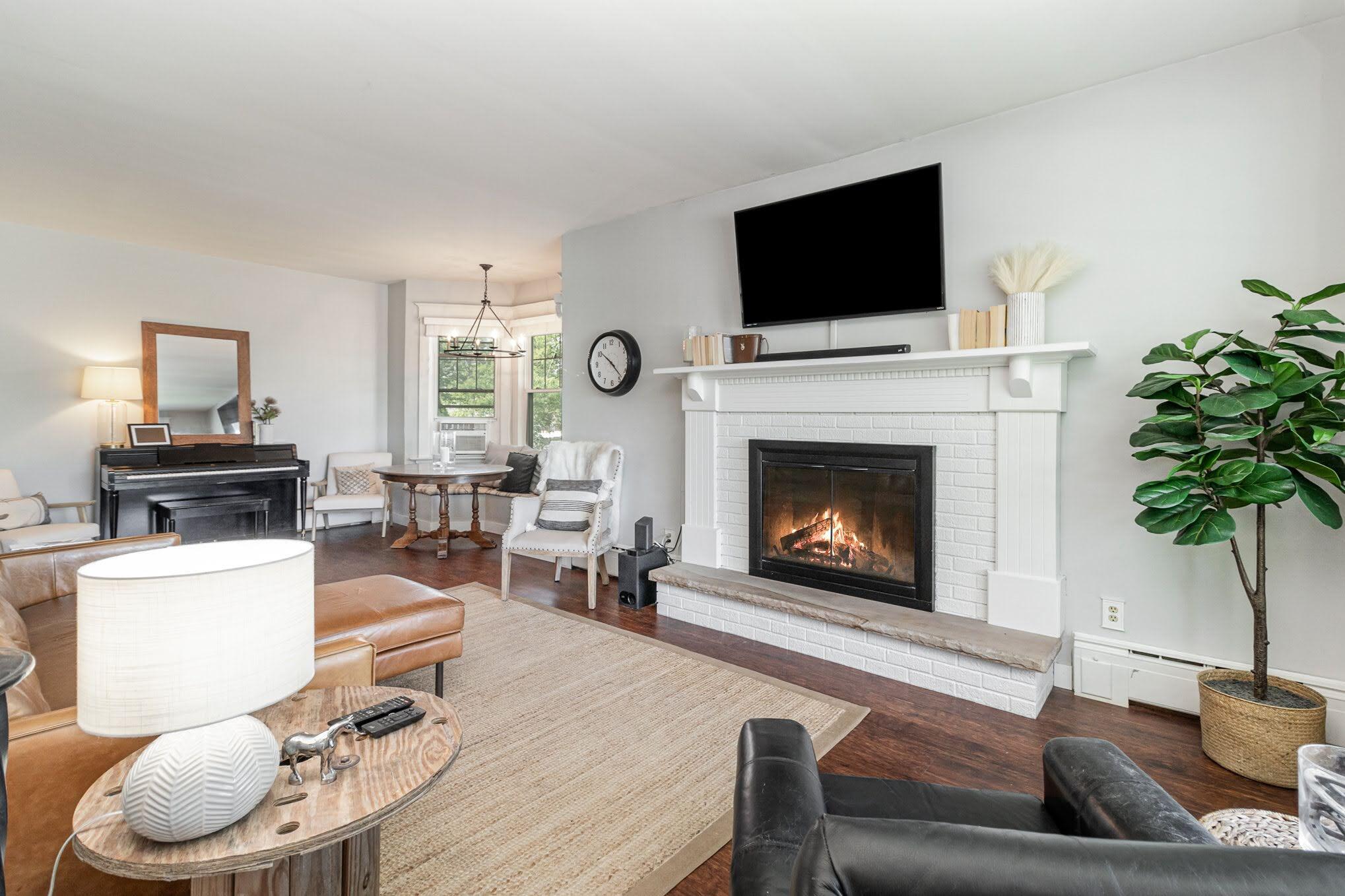 3444 Ridge Road Highland, IN 46322 - Photo 6 of 47 a living room with furniture a fireplace and a flat screen tv