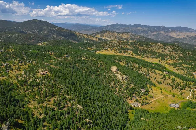 a view of a houses with a lush green hillside