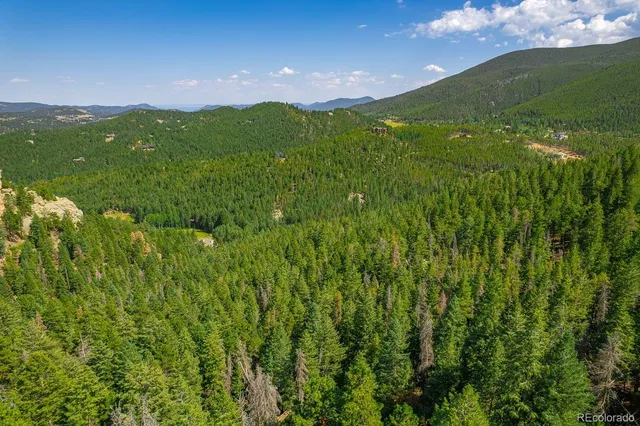a view of a lush green hillside and a building