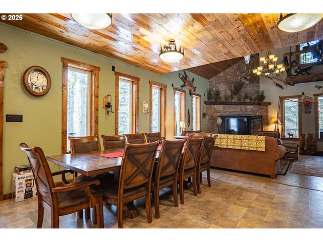 a dining hall with furniture and a large window