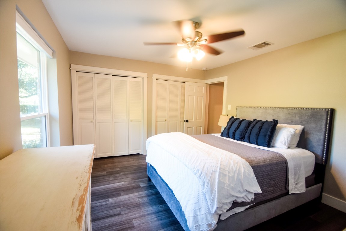 3618 Quiette Drive Austin, TX 78754 - Photo 12 of 31 a spacious bedroom with a bed and a chandelier