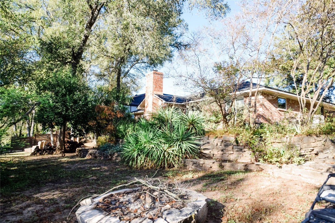 3618 Quiette Drive Austin, TX 78754 - Photo 18 of 31 a view of a yard with plants and trees