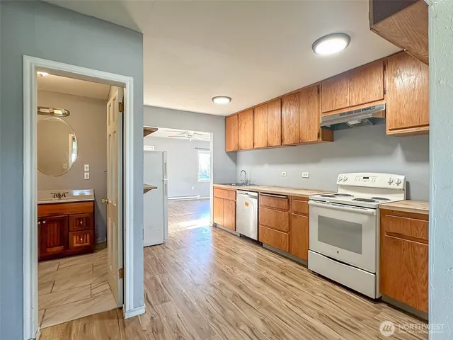 a kitchen with stainless steel appliances granite countertop a stove and a sink