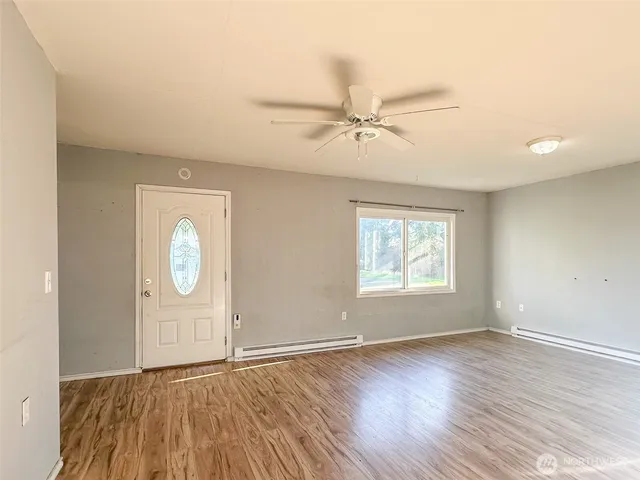 wooden floor in an empty room with a window
