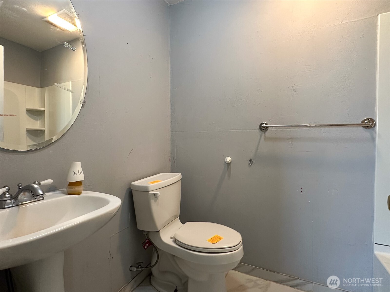 1222 West Schley Street Aberdeen, WA 98520 - Photo 23 of 31 a white toilet sitting next to a bathroom sink