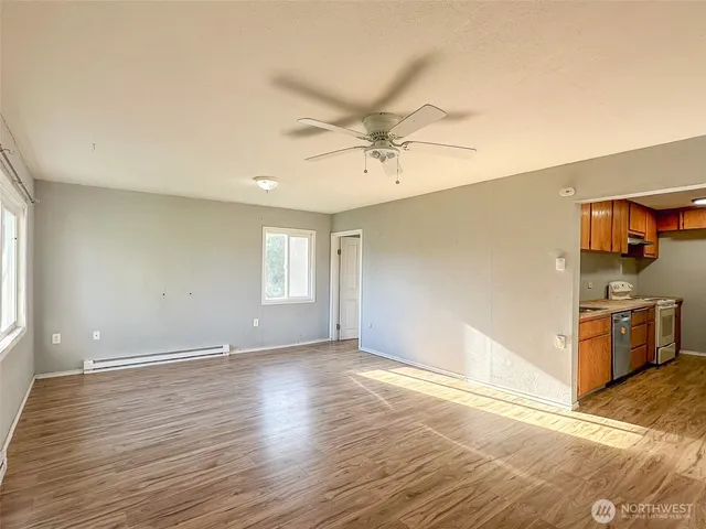 wooden floor in an empty room with a window