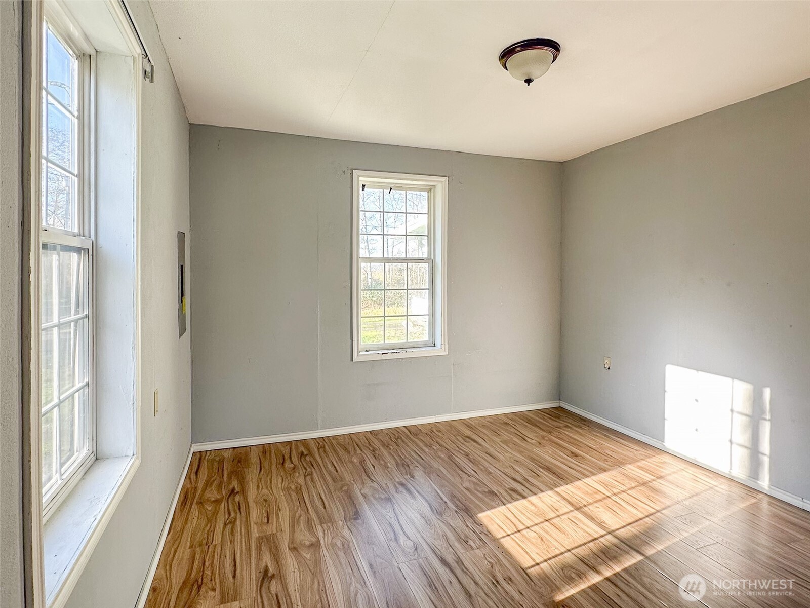 1222 West Schley Street Aberdeen, WA 98520 - Photo 10 of 31 a view of a room with wooden floor and windows