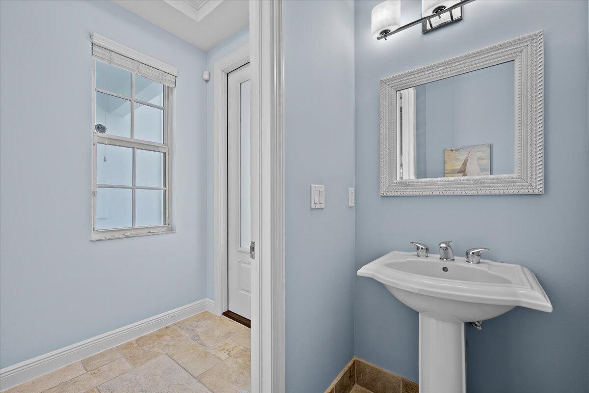 455 Ocean Ridge Way Juno Beach, FL 33408 - Photo 17 of 45 a bathroom with a sink and a mirror
