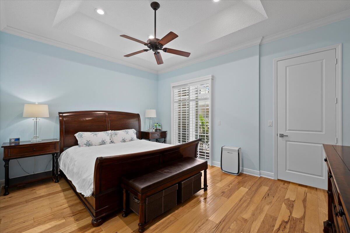 455 Ocean Ridge Way Juno Beach, FL 33408 - Photo 26 of 45 a bedroom with a bed and wooden floor