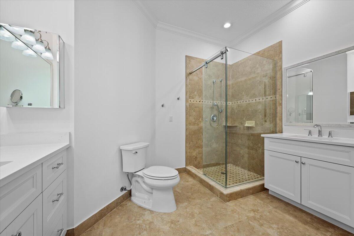 455 Ocean Ridge Way Juno Beach, FL 33408 - Photo 29 of 45 a bathroom with a shower a sink a toilet and mirror