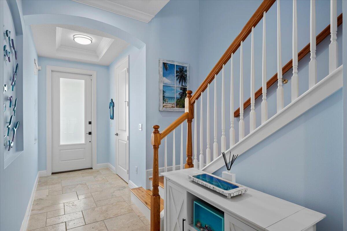 455 Ocean Ridge Way Juno Beach, FL 33408 - Photo 3 of 45 a view of an entryway with wooden floor and stairs