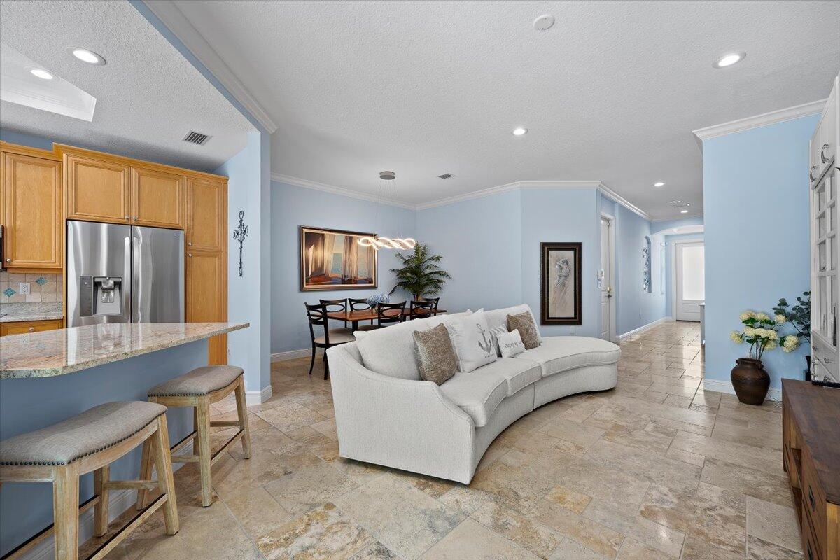 455 Ocean Ridge Way Juno Beach, FL 33408 - Photo 6 of 45 a living room with furniture and a flat screen tv