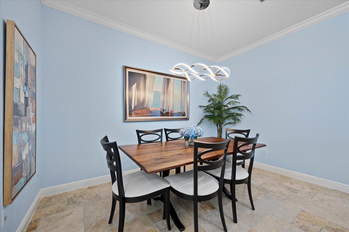 455 Ocean Ridge Way Juno Beach, FL 33408 - Photo 7 of 45 a dining room with furniture and chandelier