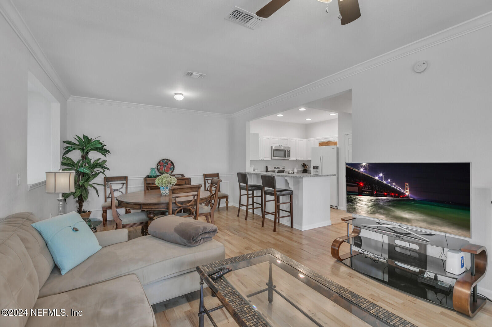 10901 Burnt Mill Road, Unit 2106 Jacksonville, FL 32256 - Photo 4 of 23 a living room with furniture and a flat screen tv