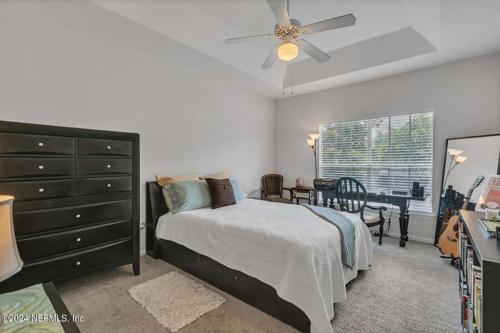 10901 Burnt Mill Road, Unit 2106 Jacksonville, FL 32256 - Photo 9 of 23 a bedroom with a bed a chandelier and a large window