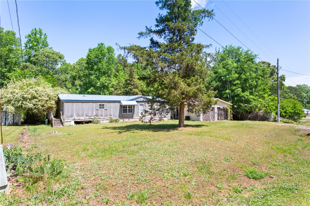 209 Short Cut Road Westminster, SC 29693 - Photo 2 of 27 This charming home features a well-maintained exterior and a spacious yard, perfect for outdoor living.