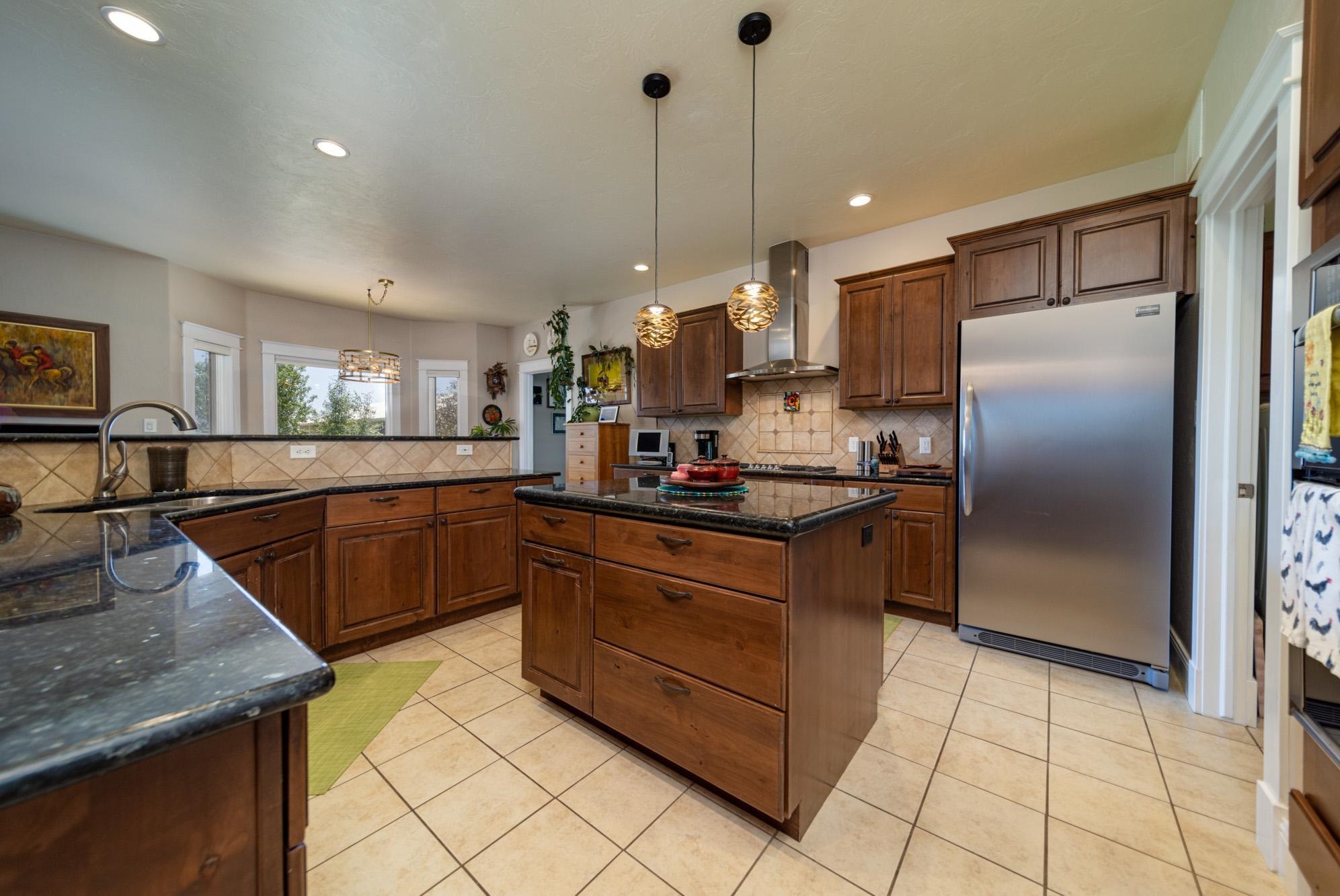 1371 Saddle Ridge Road Loma, CO 81524 - Photo 12 of 42 a kitchen with stainless steel appliances granite countertop a sink a stove and a refrigerator