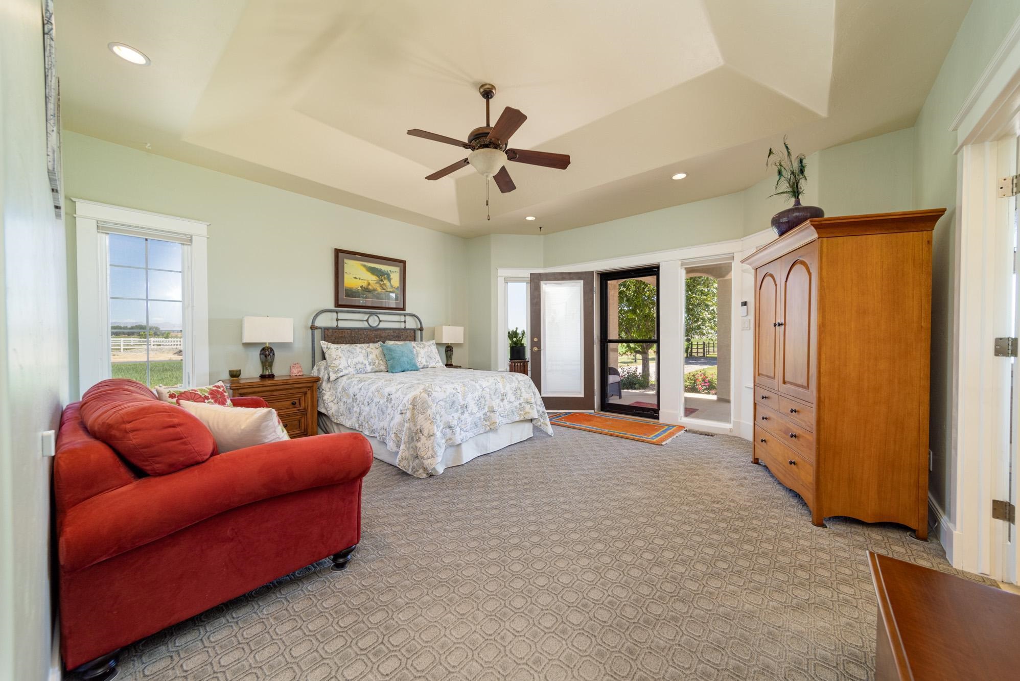 1371 Saddle Ridge Road Loma, CO 81524 - Photo 19 of 42 a bedroom with furniture and a chandelier