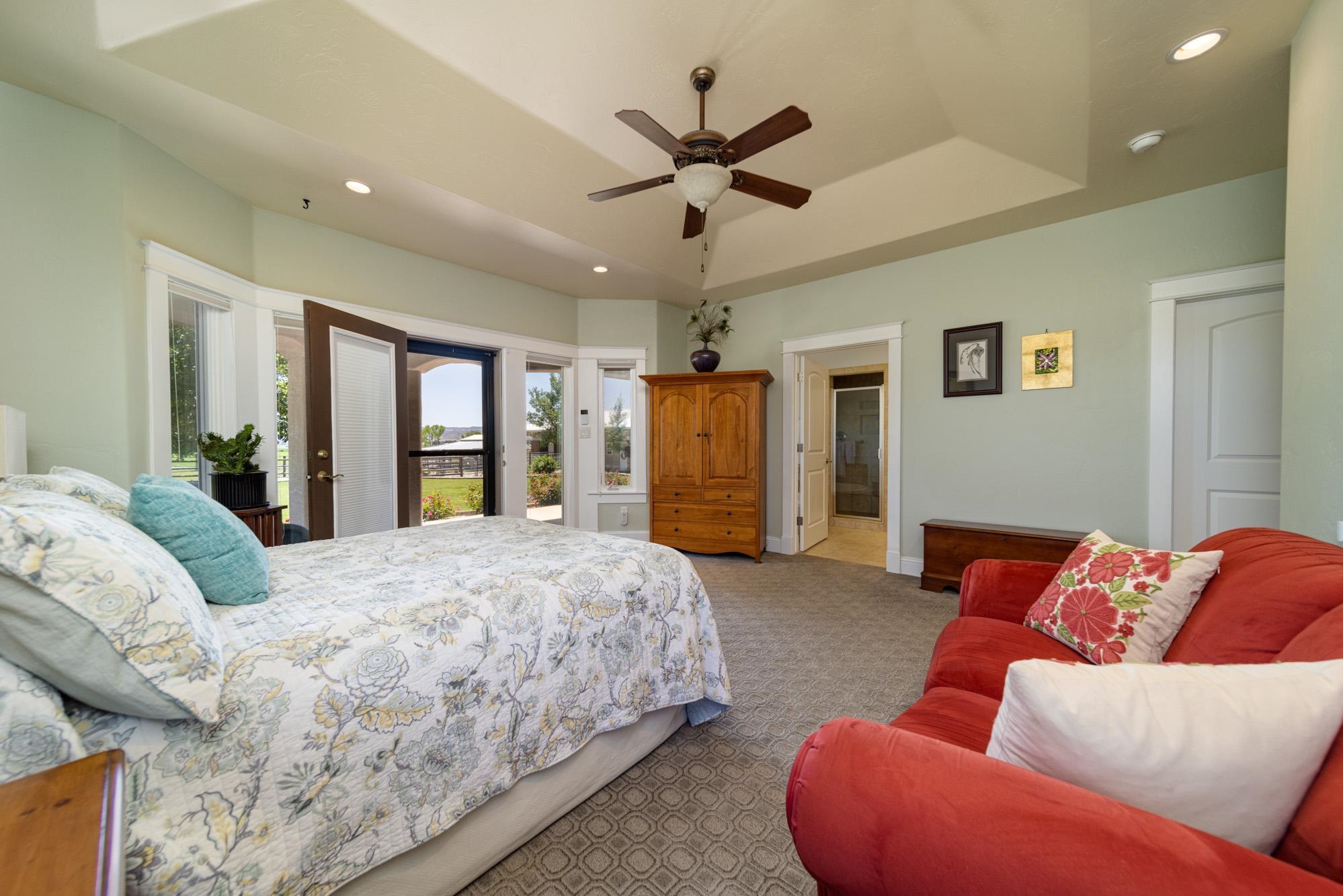 1371 Saddle Ridge Road Loma, CO 81524 - Photo 20 of 42 a spacious bedroom with a bed and ceiling fan