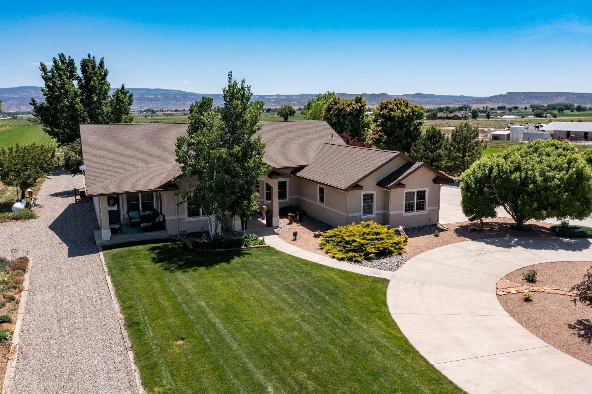 1371 Saddle Ridge Road Loma, CO 81524 - Photo 2 of 42 an aerial view of a house with swimming pool and garden