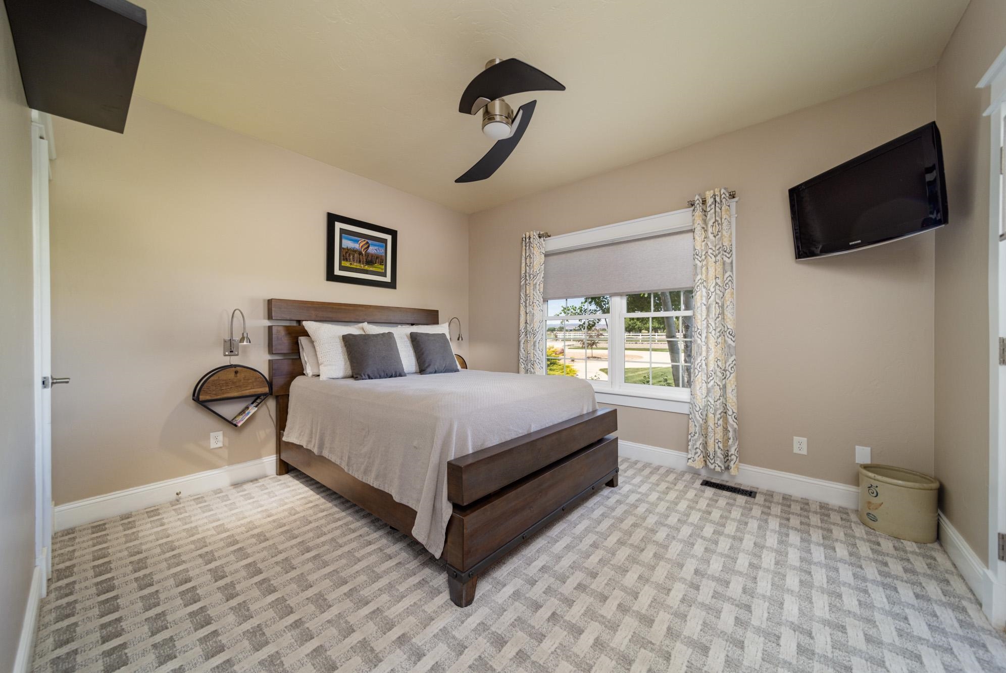 1371 Saddle Ridge Road Loma, CO 81524 - Photo 23 of 42 a bedroom with a bed and a flat screen tv