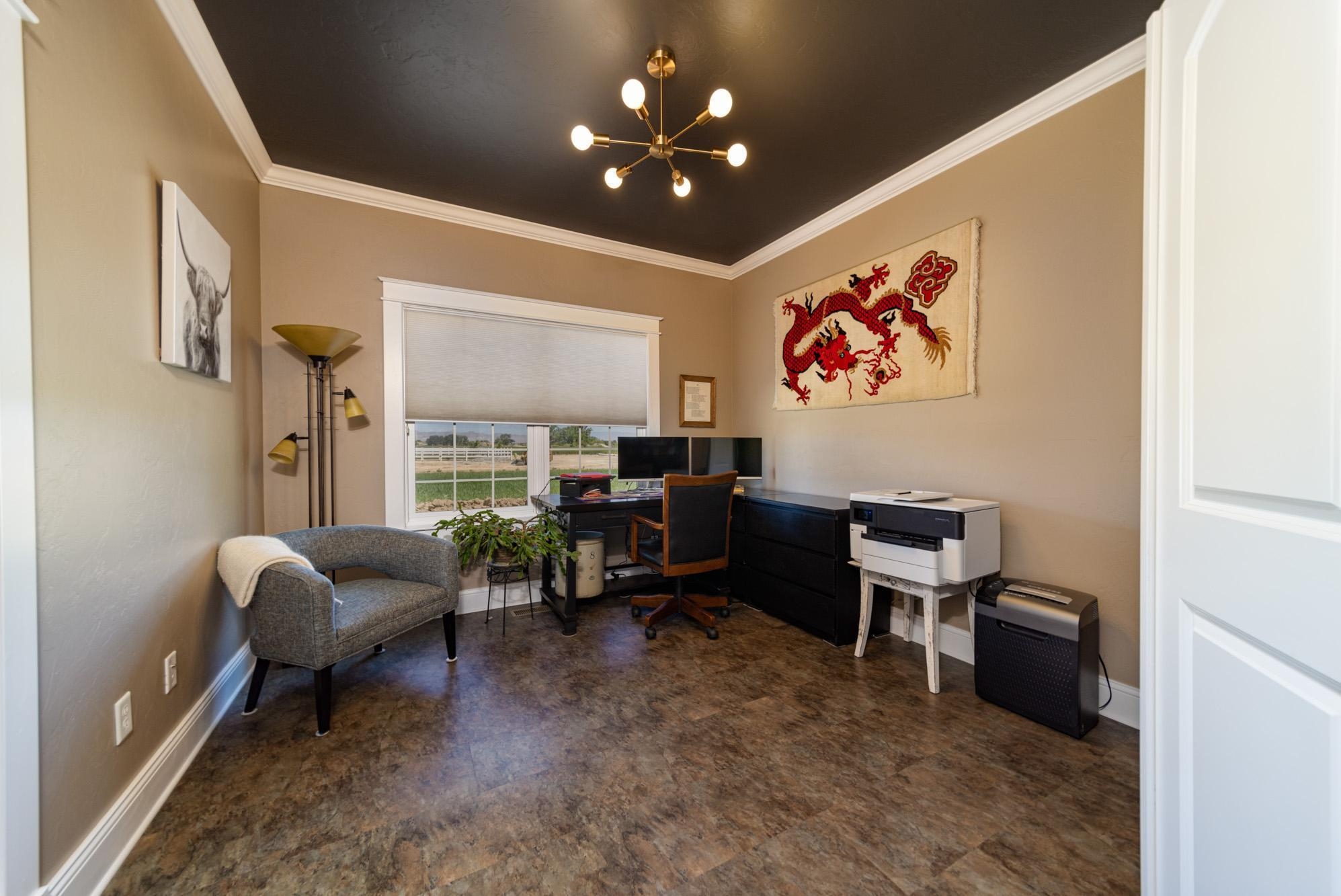 1371 Saddle Ridge Road Loma, CO 81524 - Photo 29 of 42 a living room with furniture a window and a flat screen tv