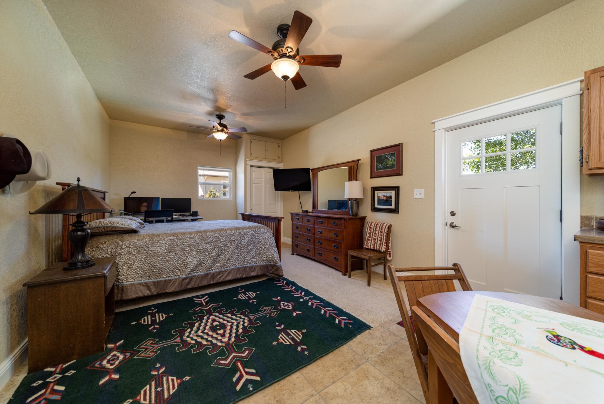 1371 Saddle Ridge Road Loma, CO 81524 - Photo 33 of 42 a bedroom with a bed and a chandelier