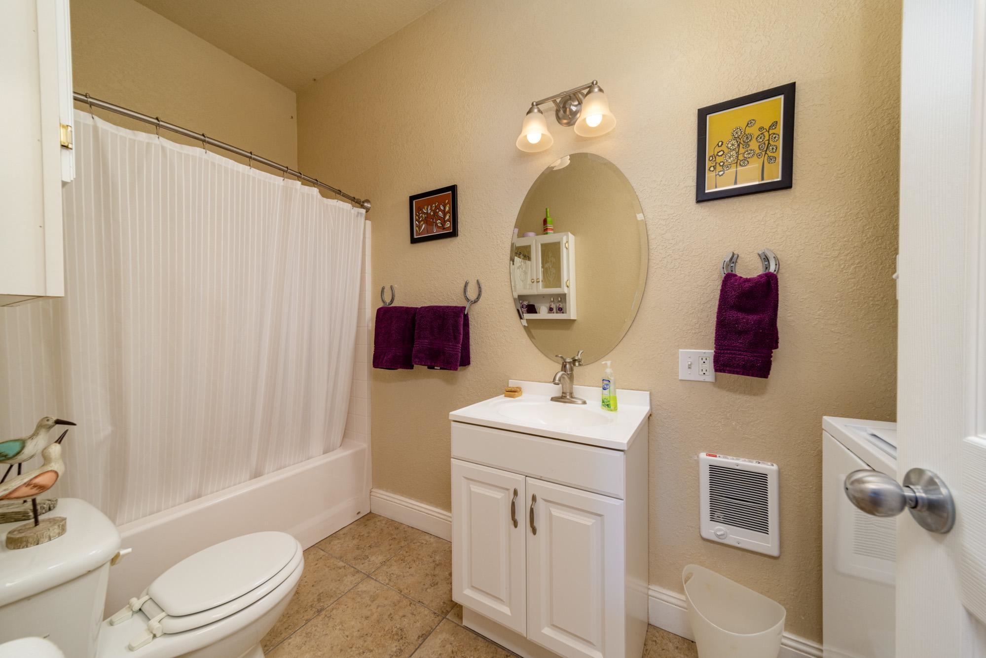1371 Saddle Ridge Road Loma, CO 81524 - Photo 35 of 42 a bathroom with a toilet sink vanity tub and shower
