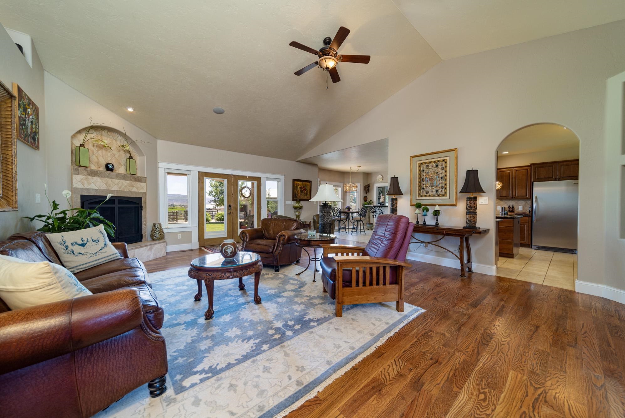 1371 Saddle Ridge Road Loma, CO 81524 - Photo 9 of 42 a living room with furniture a fireplace and a chandelier