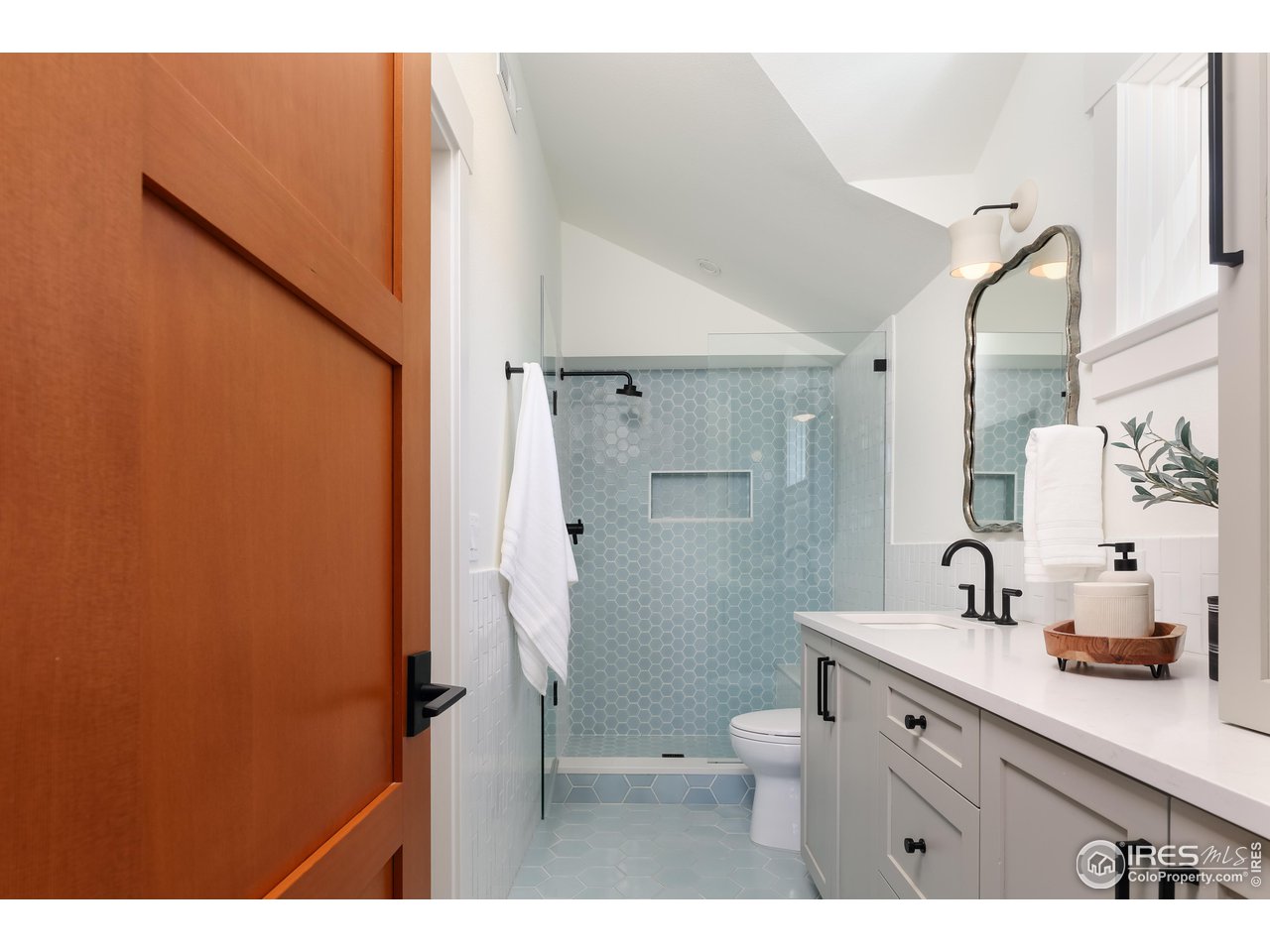 2088 Alpine Dr. Boulder, CO 80304 - Photo 22 of 37 a bathroom with a sink a toilet and shower