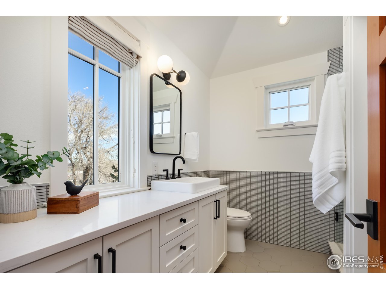 2088 Alpine Dr. Boulder, CO 80304 - Photo 24 of 37 a bathroom with a sink a toilet and a mirror
