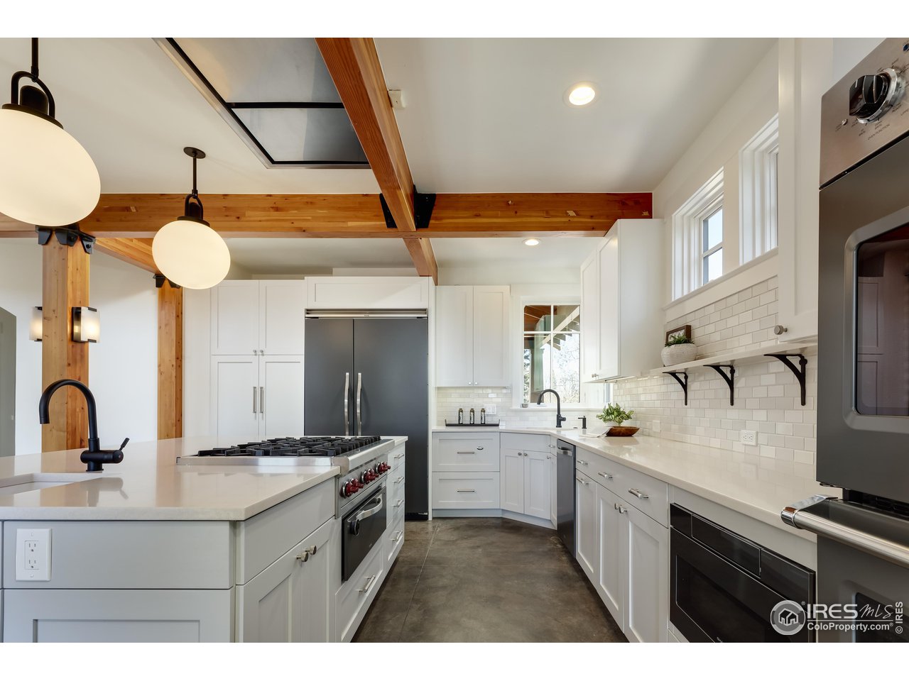 2088 Alpine Dr. Boulder, CO 80304 - Photo 9 of 37 a kitchen with a sink stainless steel appliances and cabinets