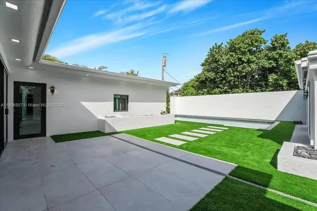a view of house with garden space and swimming pool