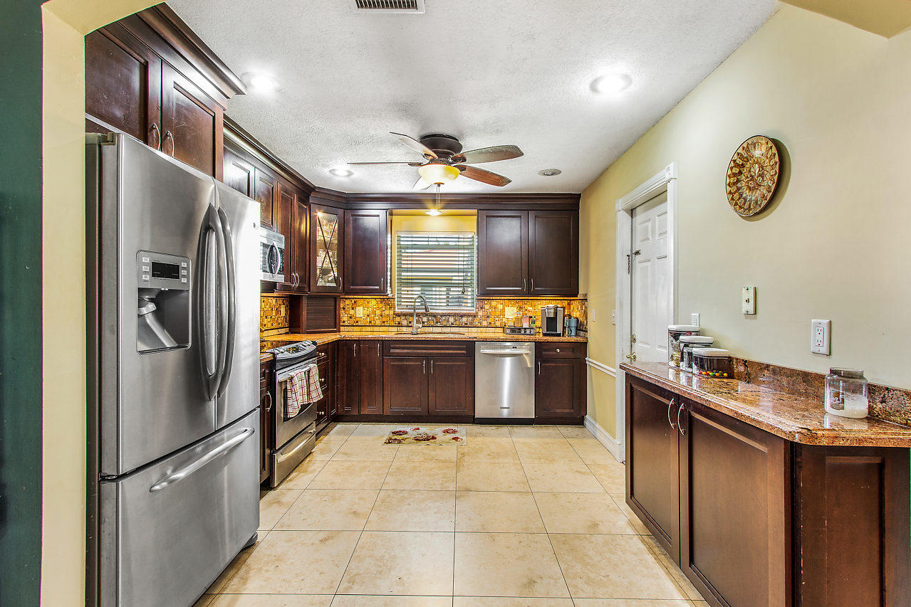 22045 Aquila Street Boca Raton, FL 33428 - Photo 7 of 24 a kitchen with a refrigerator and a sink