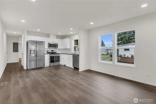 a view of kitchen with stainless steel appliances refrigerator oven and microwave
